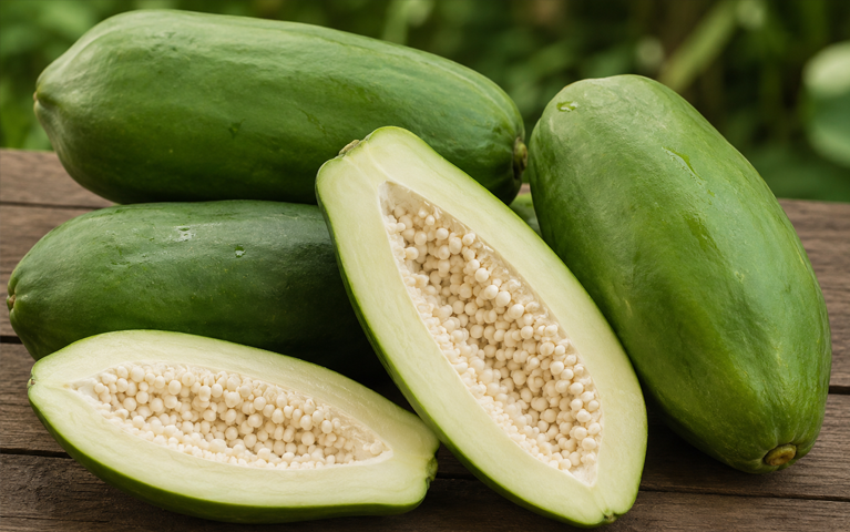 Fresh whole and cut green papaya from Sri Lanka